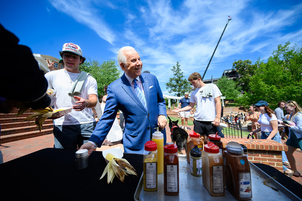 HPU President Nido Qubein mingled with students to enjoy roasted corn from Carolina Corn Roasters on Earth Day.