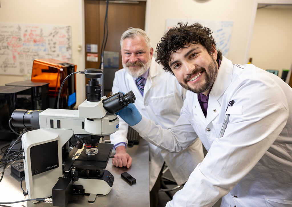 Dr. Keir Fogarty, associate professor of chemistry, smiled as he worked with Ankrum in the laboratory.