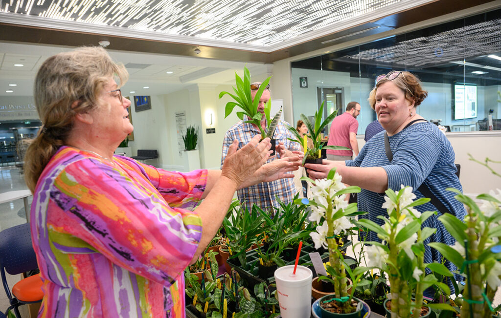 An expert shared an orchid with an attendee to take home during the 2025 show. 