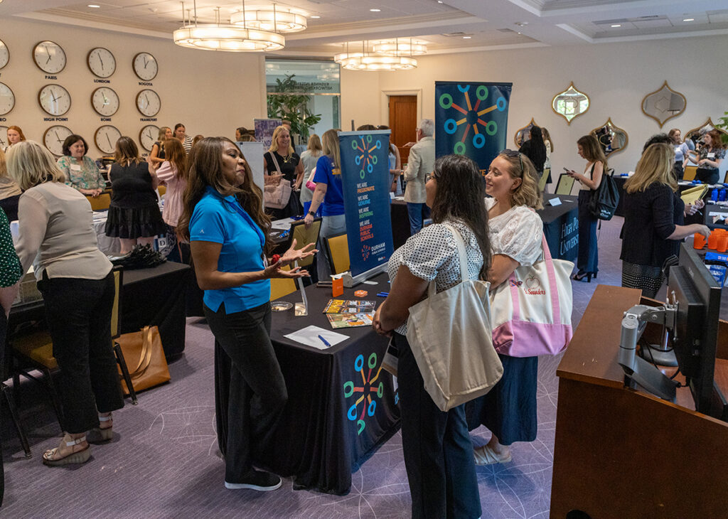 HPU education students smiled as they talked with a recruiter from the Durham Public Schools district.