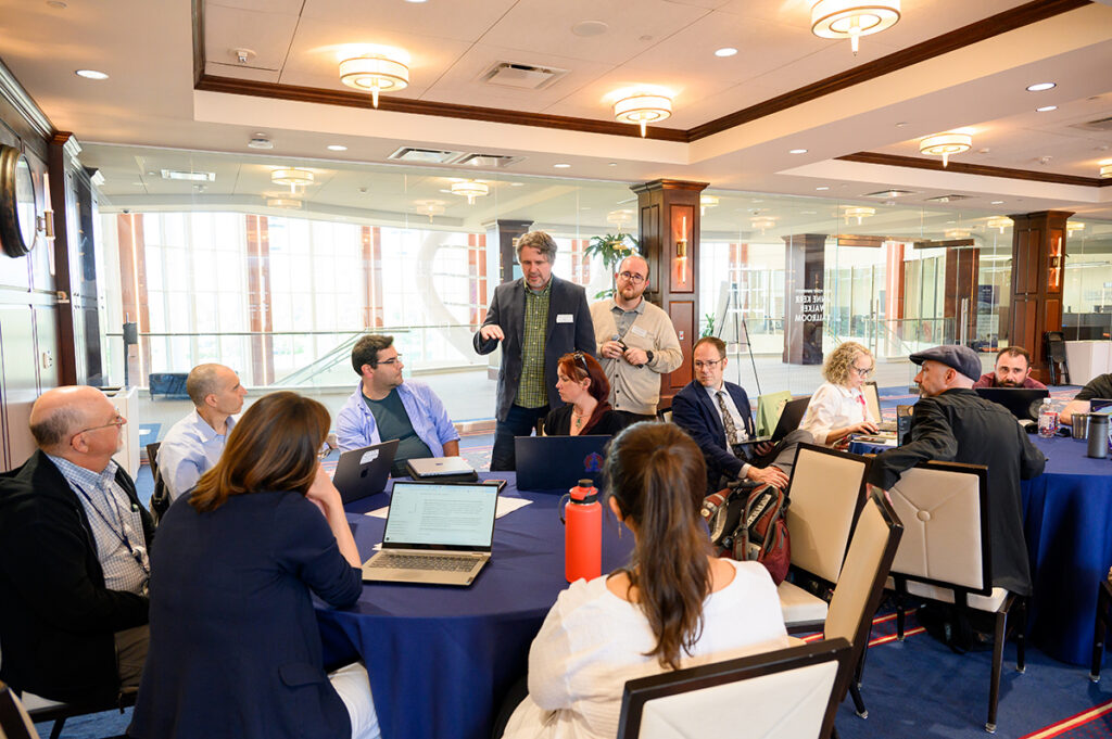 Dr. Matthew Brophy, associate professor of philosophy, and Dr. Justin Cook, assistant professor of English and director of the HPU Writing Center, are pictured leading a session on AI-assisted writing in the classroom.