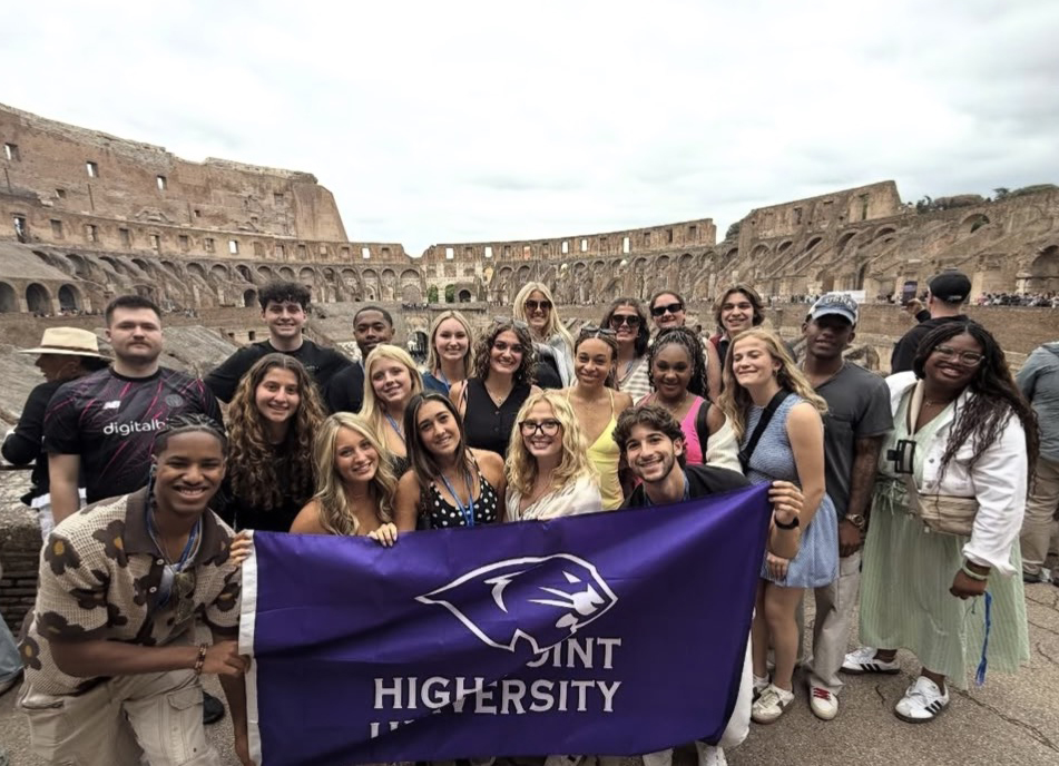 A group of students smiled as they visited the Colosseum in Rome, Italy. They were in Italy as part of a Global Experience trip known as “Sport in Society: Italy and Greece.”
