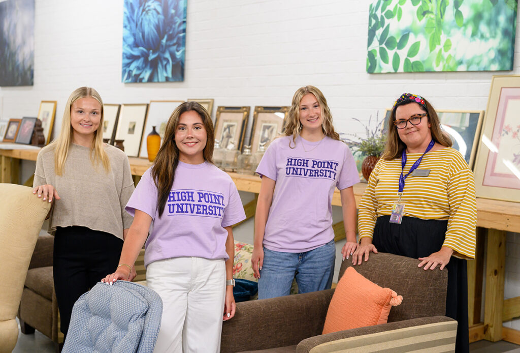Pictured from left, interior design majors Caneel Conlon, Samantha Carrara and Alexandra Fisher joined Pamela Lindeback, assistant professor of interior design, at The Barnabas Furniture Bank, a home furnishings nonprofit in the city of High Point.