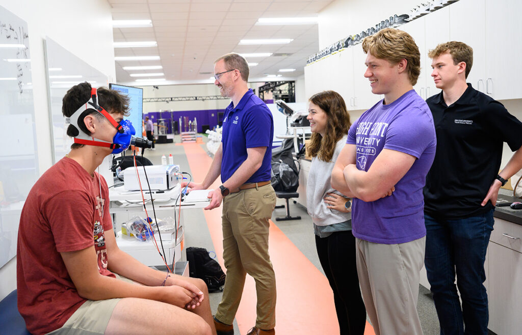 Dr. Jason Keeler and Summer Undergraduate Research Fellows BriAnna Doll, Nick Sorensen and Austin Osborne monitored a participant as he completed five maximal breath-holds to stimulate spleen contraction and used a metabolic cart to measure the inspired and expired oxygen and carbon dioxide of each breath-hold to see how physiological variables change.