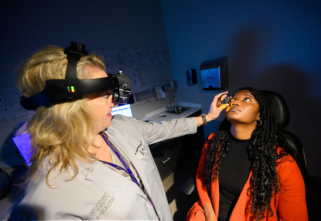 Dr. Bade conducts an eye examination for a community member.
