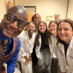 Rep. James Roberson, left, with Nathalie Ortiz Pate, right, and other physician assistants.