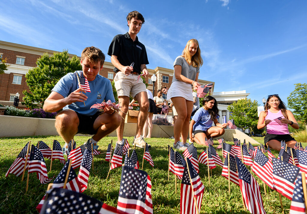 SGA President Asher Wimberly, center, led students as they planted flags in remembrance of Sept. 11.