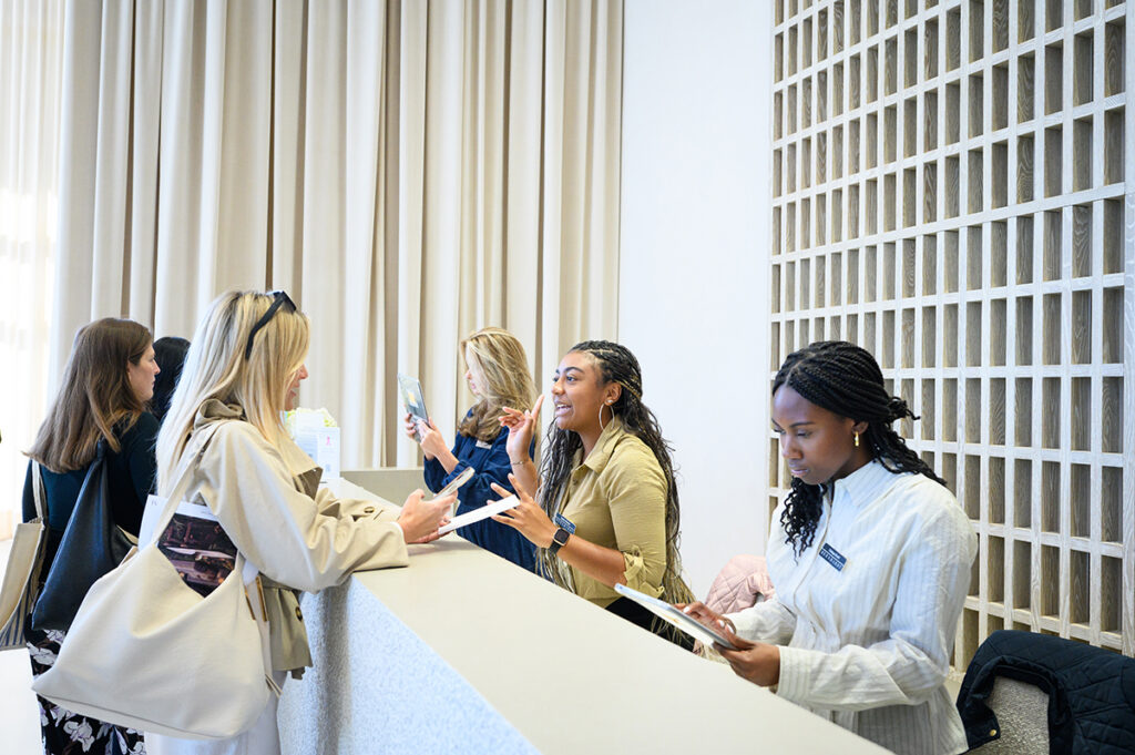 Destiny Webster, a junior interior design major and home furnishings business minor, was pictured second from right as she assisted a buyer in the Bernhardt showroom lobby. On the right, Cristique Duvall, a junior interior design major from Abingdon, New Jersey, checked a registration.