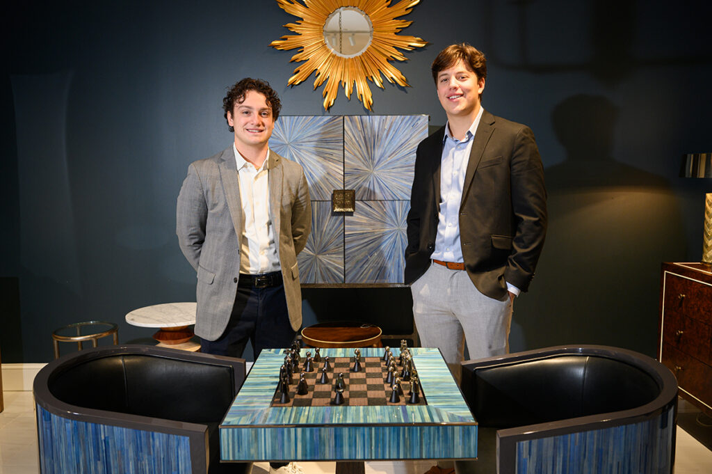 Nate Evangelista, a senior sales major from Winthrop, Massachusetts, and Yoav Hertz, a junior finance major from Demarest, New Jersey, worked in the Jonathan Charles Fine Furniture showroom.
