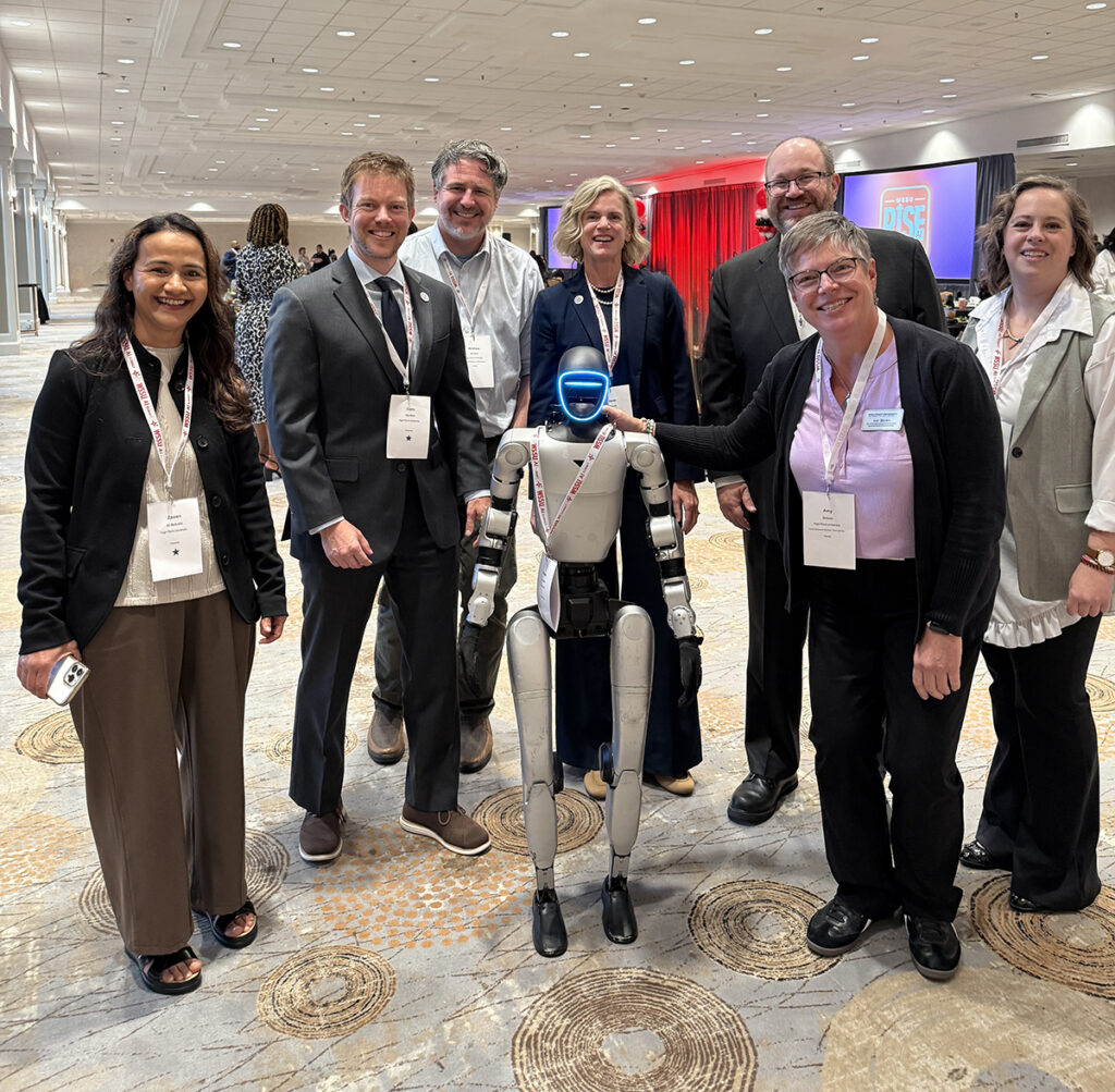 Six HPU faculty members were chosen to present at the RISE AI Summit on Sept. 10 at Winston-Salem State University in Winston-Salem, North Carolina. Faculty pictured at the AI Summit with a humanoid robot were Dr. Zawan Al Bulushi, left, Dr. Colin Carriker, Dr. Matthew Brophy, Heidi Echols, John Mims, Amy Brown and Katy Brandt.
