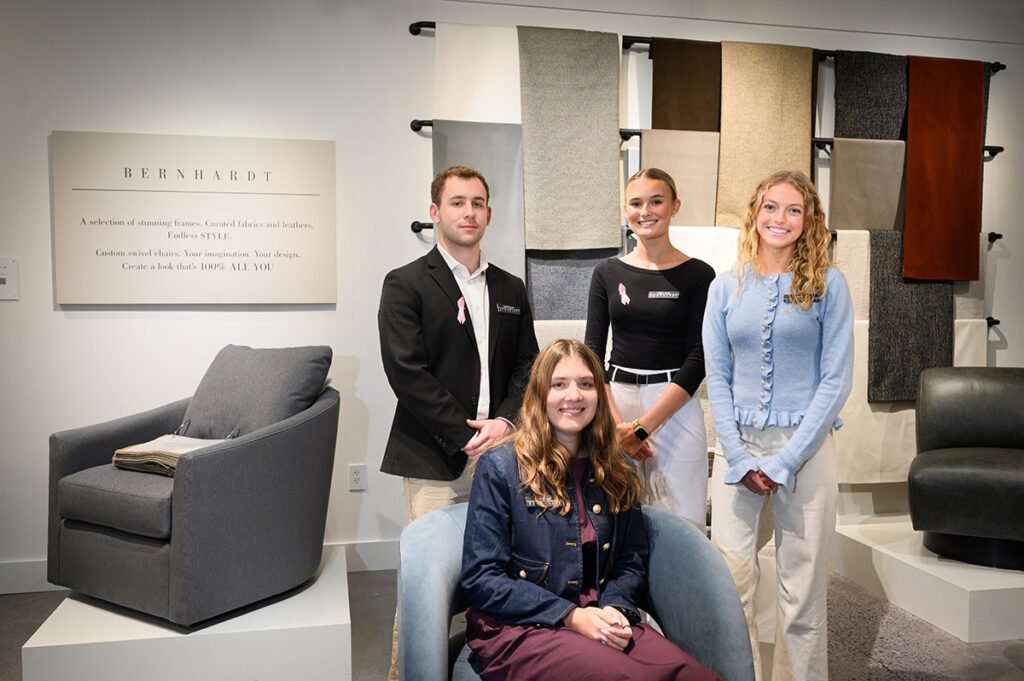 Mia Zuccaro was seated in the Bernhardt showroom with Marc Ciampolillo, Kaitlyn Young and Alexandra Cooper standing behind her.