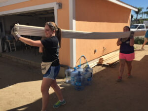 Kerri Madden (left) and Juls Zipp (right) volunteer at the Magnolia Street worksite.