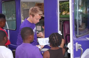 Sophomore Anthony Lindauer offers ice cream to the boys. 