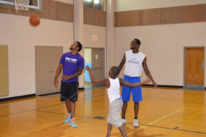 HPU basketball players K.J. James (left) and John Brown (right) playing basketball at the event. 