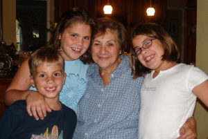 Claudia (right) with her siblings and her grandmother, Rosario Martinez