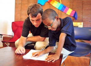 Junior Patrick Duggan reads with a second grader from High Point.