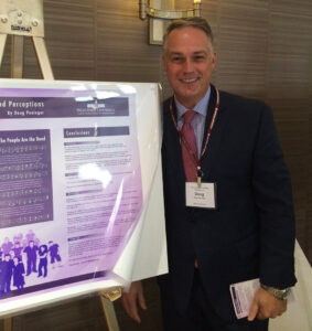 Graduate student Douglas Peninger presents a poster of his research. 