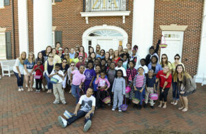 The photo features local elementary school students in the PNAC program and High Point University’s Zeta Tau Alpha sorority.