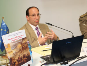 Schneid presents his book to the audience at the book fair. 