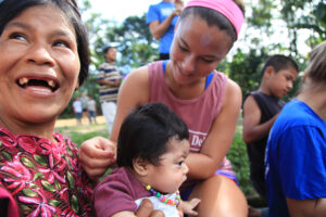 Caitlin Kane puts a beaded necklace on one of the babies in a Guatemalan village. 