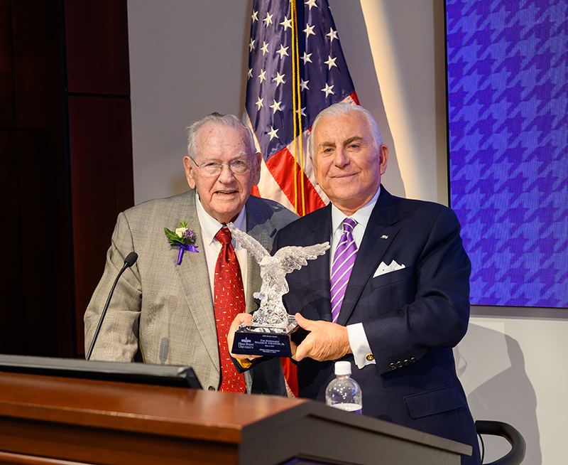 The Honorable William D. “Bill” Goldston Jr., Class of 1947, left, with the Lifetime Achievement Award presented by HPU President Nido Qubein, right.