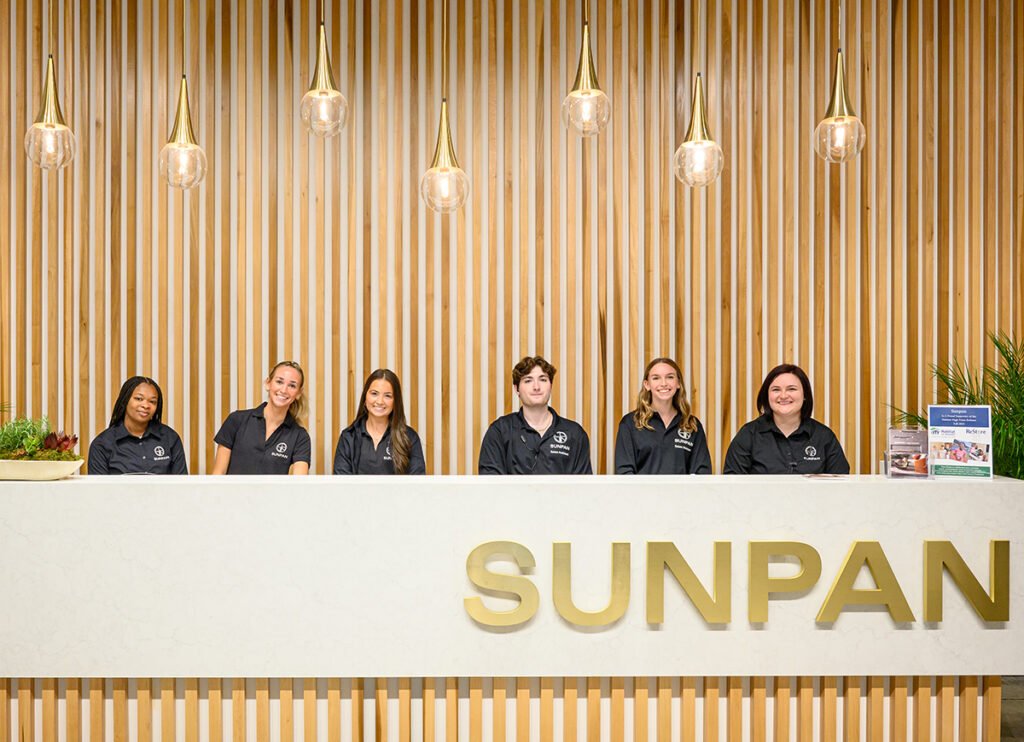 From left, working at the SUNPAN furniture registration desk are HPU students Beverly Yarborough, a senior computer science major from Raleigh; Ashley Levister, a senior business administration major from Yorktown, Virginia; Ella Ott, a freshman business major from High Point; Ridge Lanzi, a senior business administration major from Greensboro; Hayley Bracci, a senior interior design major from Stow, Massachusetts; with Lilly Wingate, a 2017 nonprofit leadership and management major from Bainbridge Island, Washington.