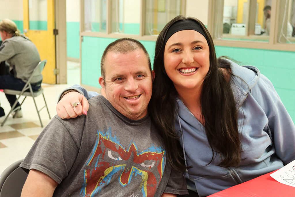 Claire Cassell, a special education adapted curriculum major and co-president of HPU‘s Council for Exceptional Children from Hingham, Massachusetts, hugs a High Point man she befriended through special populations events.