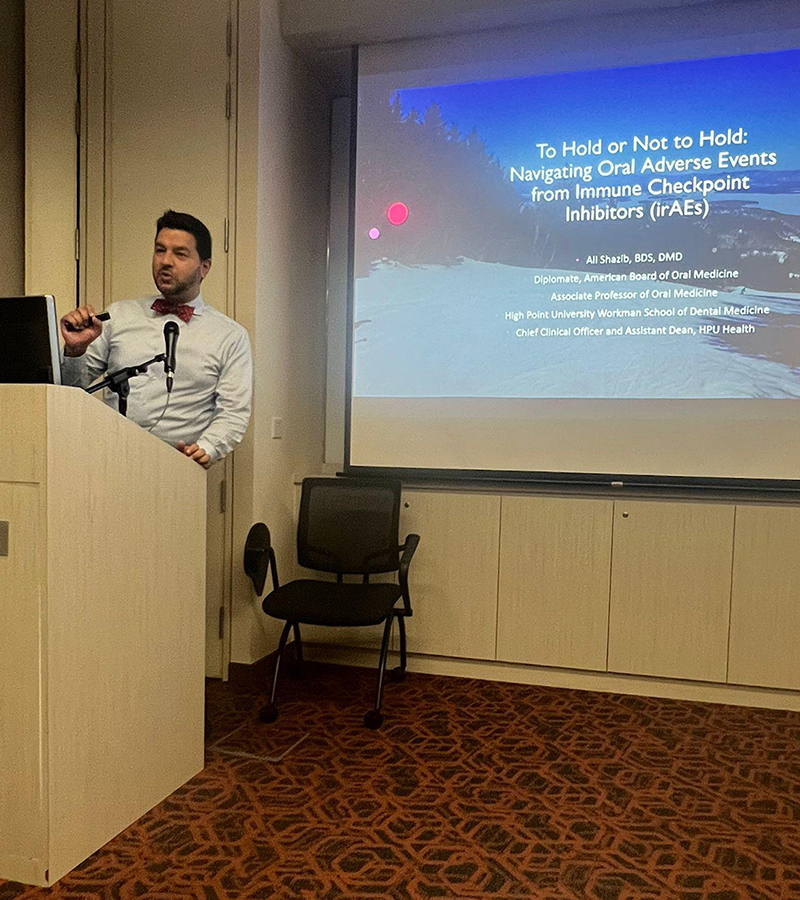 Dr. Ali Shazib, associate professor and dean for practice of the Workman School of Dental Medicine and chief clinical officer of HPU Health LLC, presents research on the effects of emerging oral cancer therapies at the National University of Singapore (NUS).