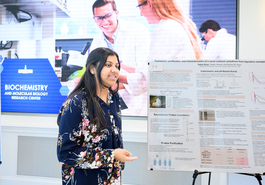 Nadia Khan, a junior biology major from Summerfield, North Carolina, discusses her research at the SuRPS poster presentation.