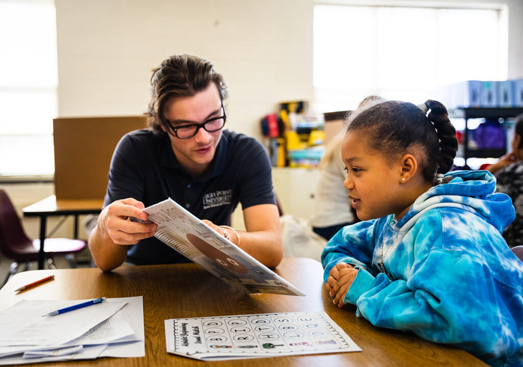 Taylor Guyton, a senior elementary education major, tutors second-grade student Genesis Mota at Fairview Elementary School in High Point, North Carolina.
