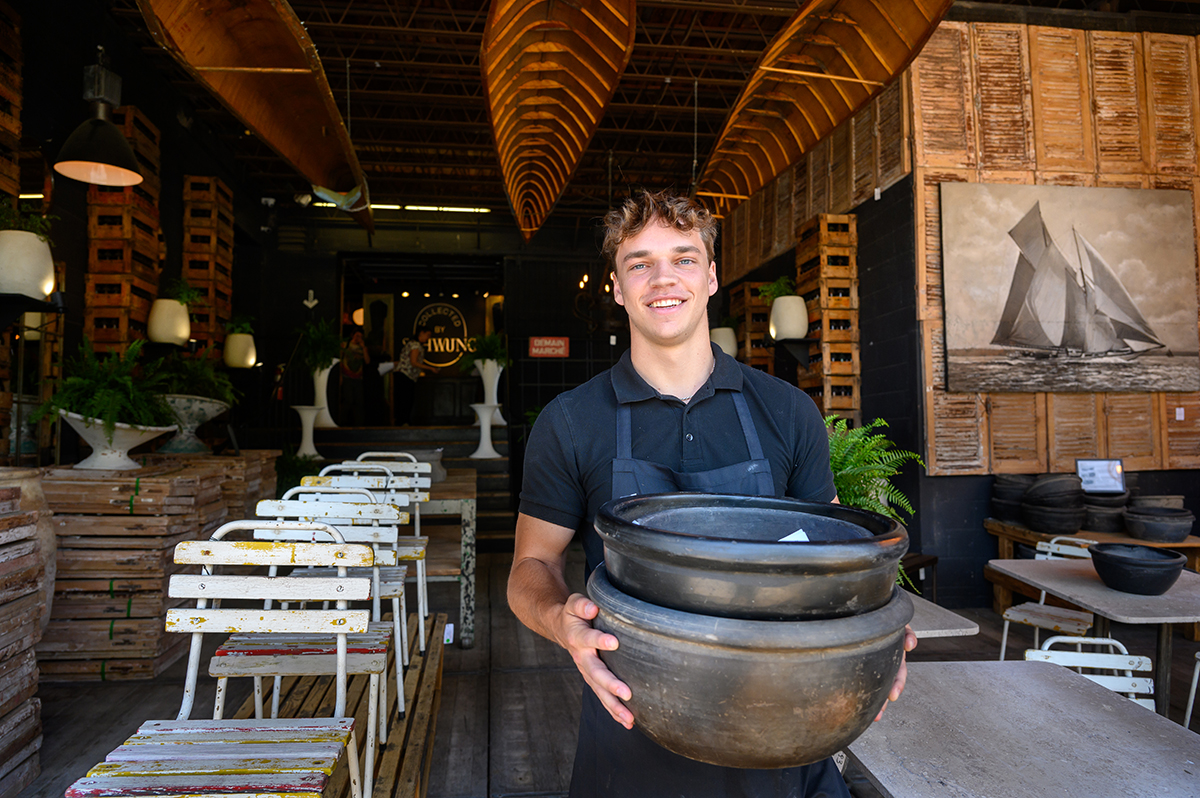 ) Jonah Johnston, a senior business administration major from Lake Norman, North Carolina, carried pottery for customers as he worked as a sales representative for Collected by Schwung.