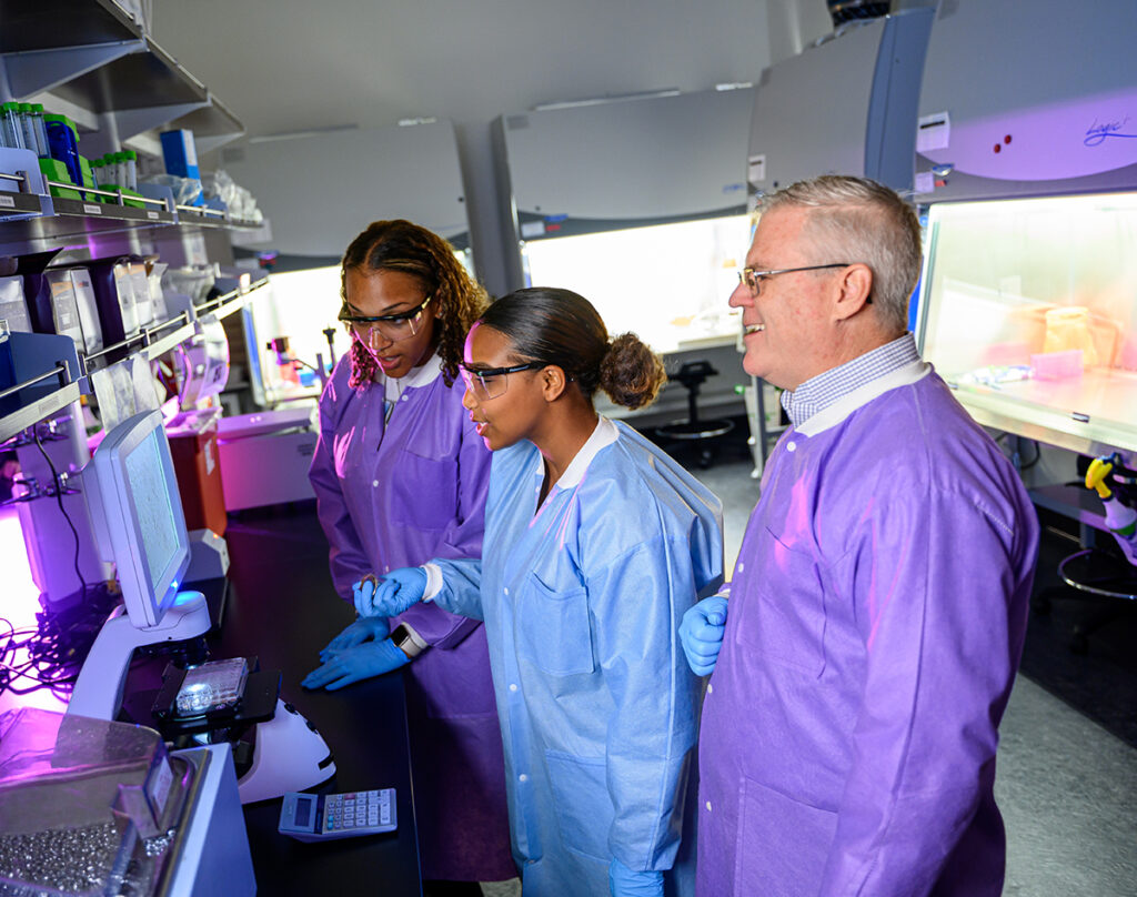 From left, students Sheridan Johnson and Anaiya Whitaker, review research findings with Dr. Mike Grider, assistant professor of biology and interim director of the neuroscience program.PU 6 neuroscience