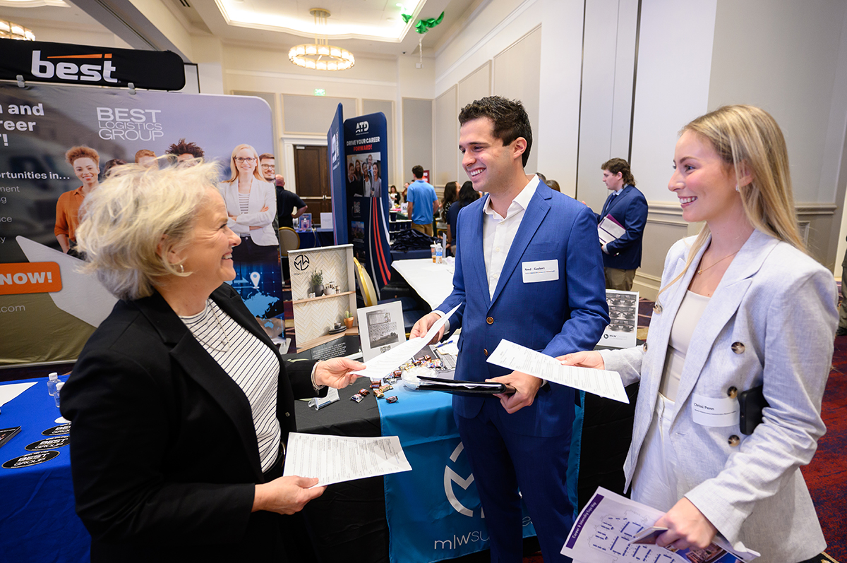 Students dressed professionally and arrived with resumes to talk with recruiters. Pictured at right sharing her resume is Chrissi Penn, a 2023 HPU business administration graduate from Columbus, Ohio, who is working toward a master’s degree in communications and business leadership.