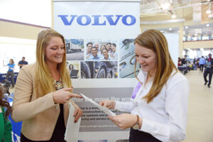 The photo features HPU student Mary Scofield (left) and 2014 graduate of HPU Paige Risner (right) who works for Volvo Group. 