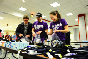 In the photo (left to right), HPU students Jose San Miguel, Manning Franks and Alysandra Zuber pack kits of essential items to be distributed to the homeless and United Way agencies on Martin Luther King Jr. Day of Service.