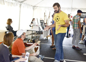 Community members discuss artwork with vendors.