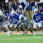 The photo features the HPU Men’s Lacrosse game against Duke University.