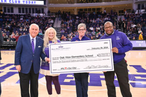 High Point University President Nido Qubein presented a check Oak View Elementary School.