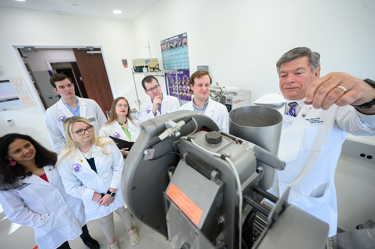 HPU Pharmacy Donation, Dr. Bradley Clark demonstrates one of the 14 pieces of equipment.