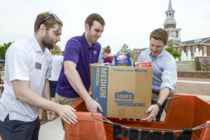 From left to right, Glen Buickerood and Lance Dunlap, staff members from the Office of Student Life, and Preston Davis, minister to the university, load 2,000 pounds of food donations onto a United Postal Service truck. 