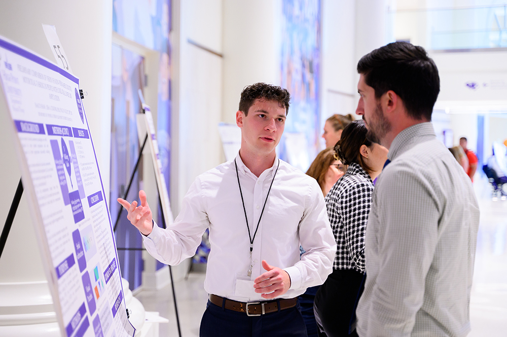 Senior Isaac Shaw presented his exercise science research to attendees at the High-PURCS event. 