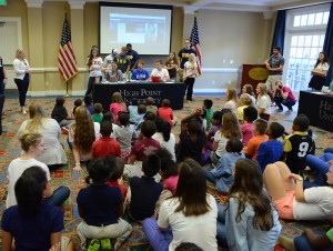 Children from the Boys and Girls Club observe a simulated volcanic eruption.