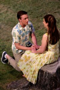Lauren Henkel Engler, Theatre and Studio Art graduate, sits atop the tree stump she painted for High Point University's 2013 production of "Picnic."
