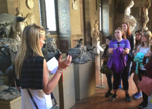 Junior Danielle Dietz, left, presents information on a series of bird sculptures by Ammanati at the Bargello Museum in Florence. In addition to drawing the places they visited, students researched and presented a work of art during the trip.