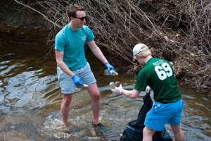 Anthony Vita and Josiah Howard collect waste from the waters.