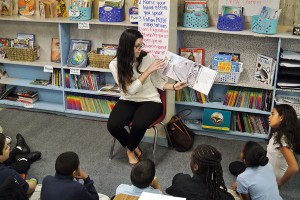 HPU education major Brianna Millewski reads a book to the children at Kirkman Park Elementary School at the beginning of the event.