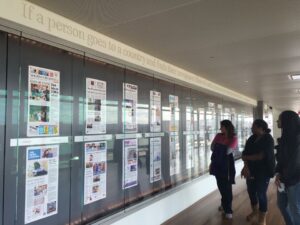  In the photo, students read front pages of the day from newspapers across the country.