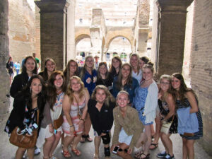 Students pause for a photo during a guided tour of the Coliseum in Rome, Italy.