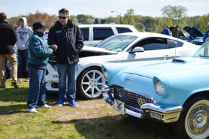 Community members look at vehicles on display at the event.