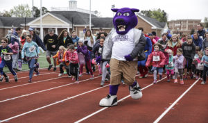 HPU’s Prowler the Panther leads the race at the Super Hero Dash. 
